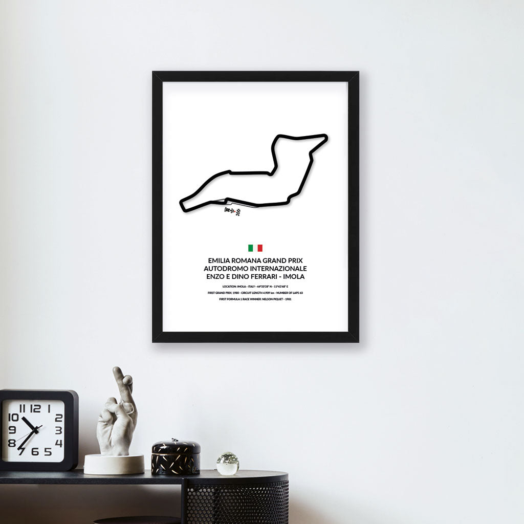 Imola Grand Prix wall art by Siluet on a white wall above a black console with a clock and small scuptures